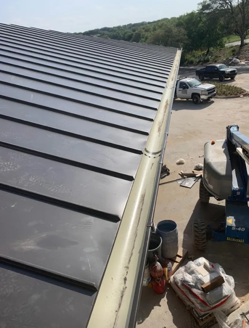 Standing seam panel and gutter detail on a metal roofing jobsite in Portsmouth